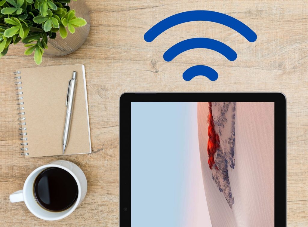 tablet convertible sobre escritorio con señales de wifi