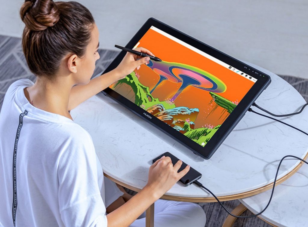 Joven dibujando sobre la tablet grafica de primera calidad Huion Kamvas 22 Plus