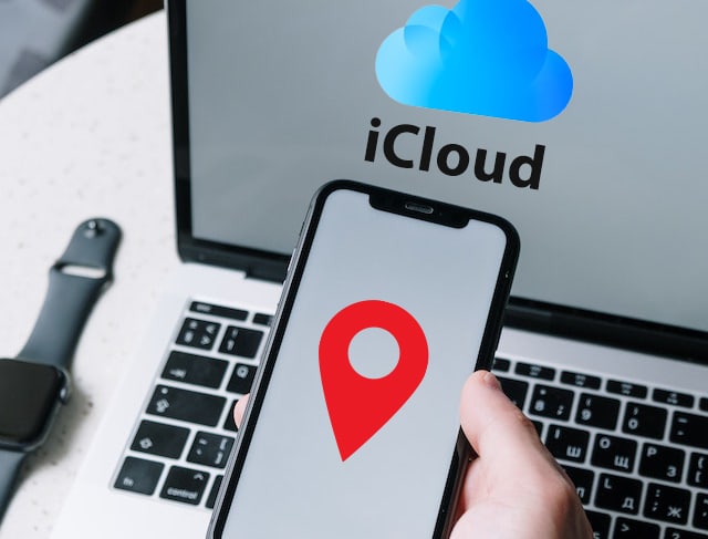 mano sosteniendo un teléfono que está siendo rastreado por el ordenador que está detrás usando la página de iCloud