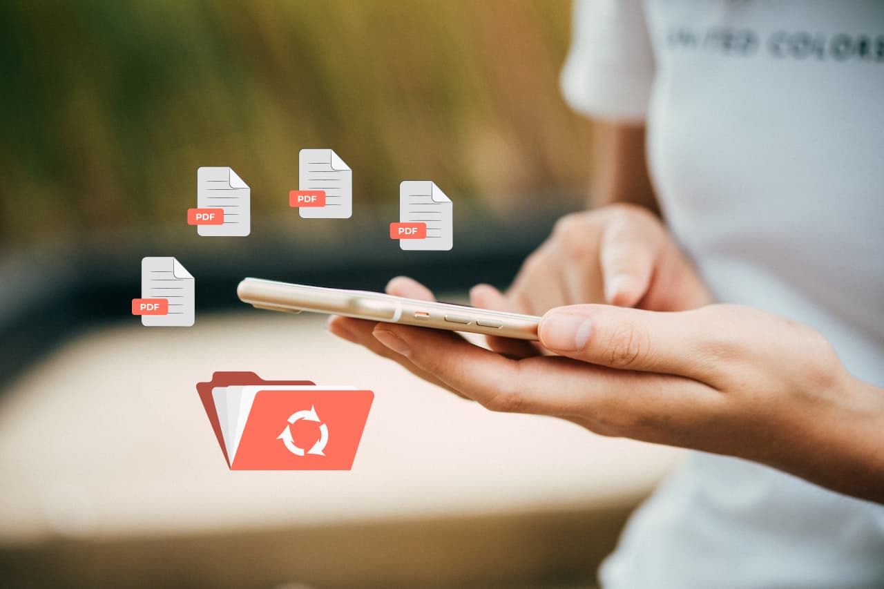 manos sosteniendo un teléfono móvil rodeado de íconos de archivos PDF recuperados